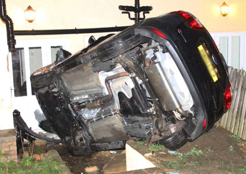 ELDERLY COUPLE TRAPPED AFTER CAR COLLIDES INTO FLATS