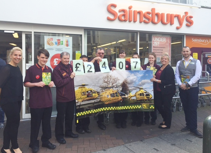 COWES SUPERMARKET HANDS OVER CHEQUE TO AIR AMBULANCE