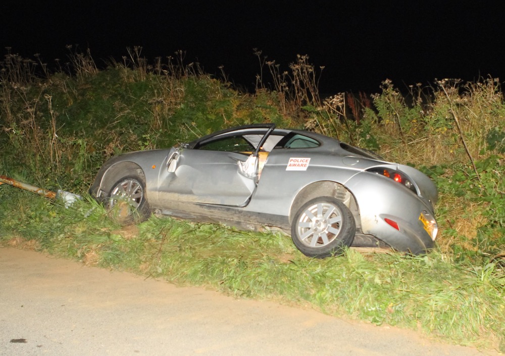 PERSONS TRAPPED AS CAR LEAVES CARRIAGEWAY