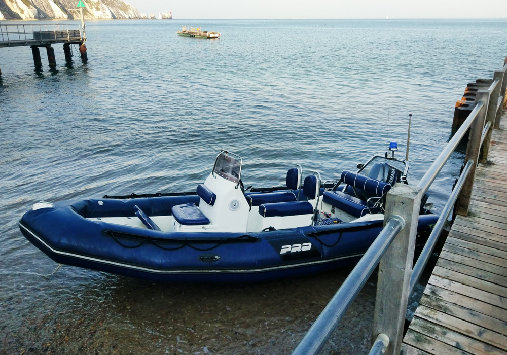 COASTGUARD USE MAN POWER TO REFLOAT BEACHED RIB