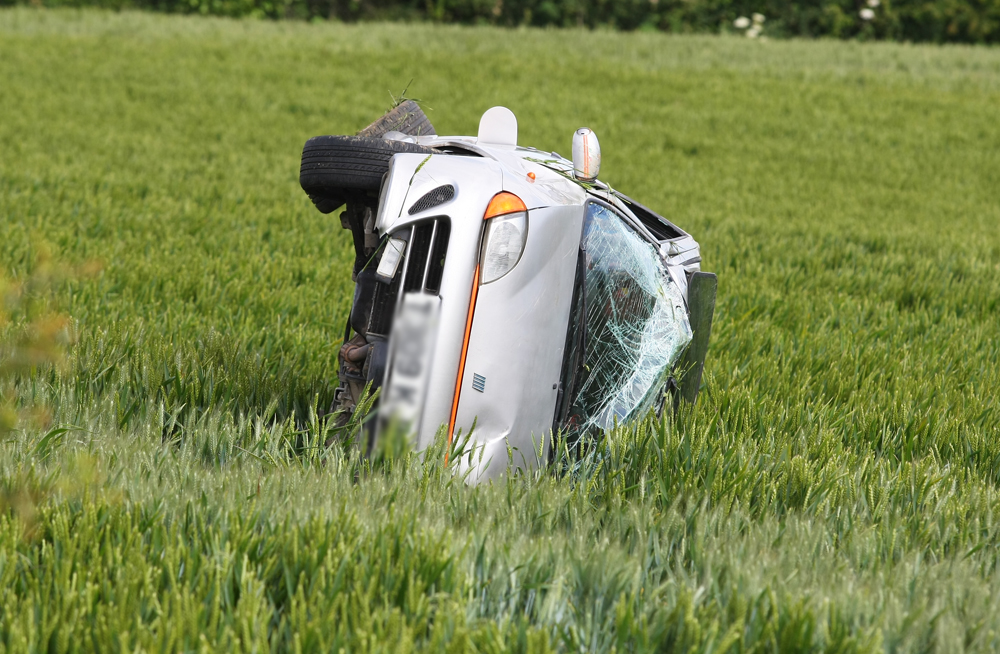 CAR ROLLS INTO FIELD ON BRADING DOWN