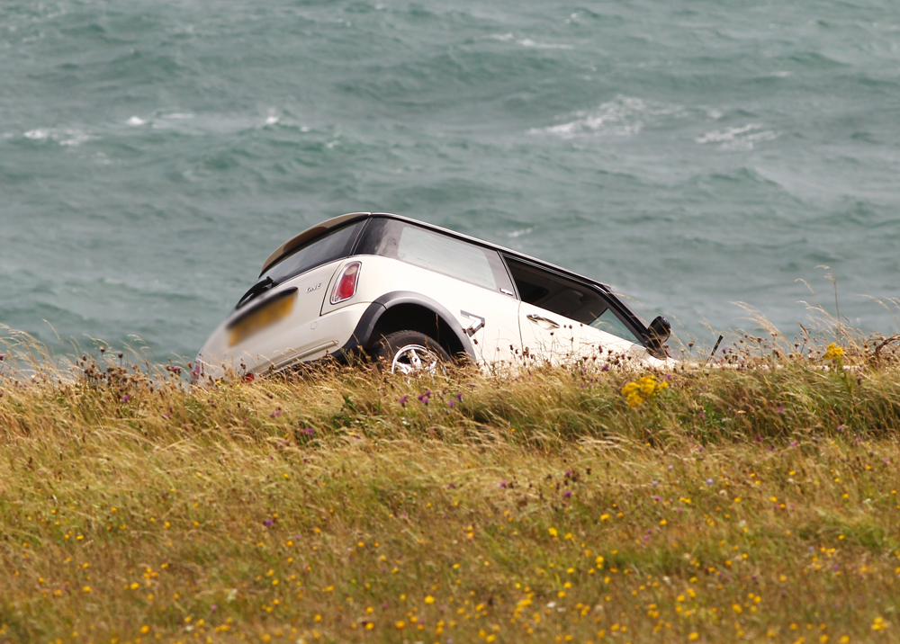 CAR TEETERING ON THE EDGE OF CULVER CLIFF