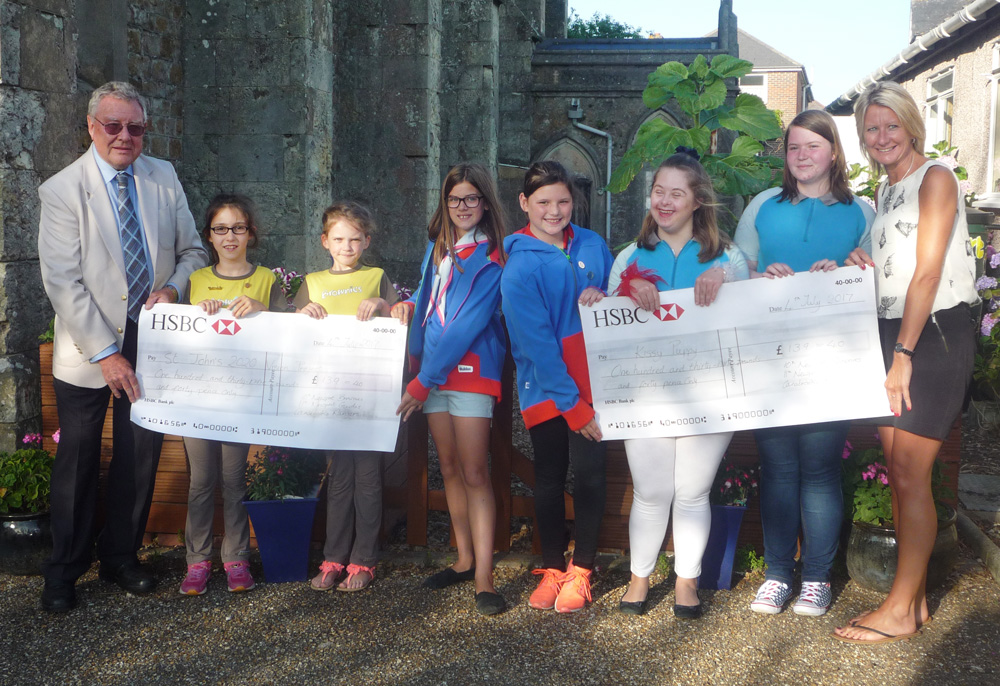 GIRLGUIDES PRESENT CHEQUES TO LOCAL WORTHY CAUSES