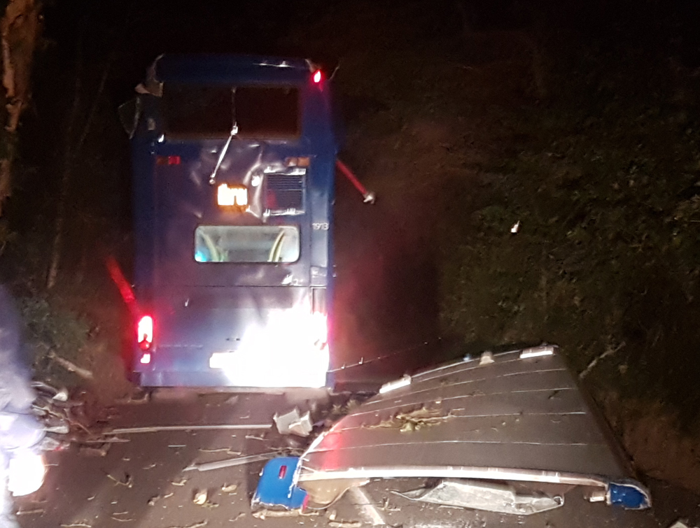 BUS LOSES ROOF IN TREE COLLISION