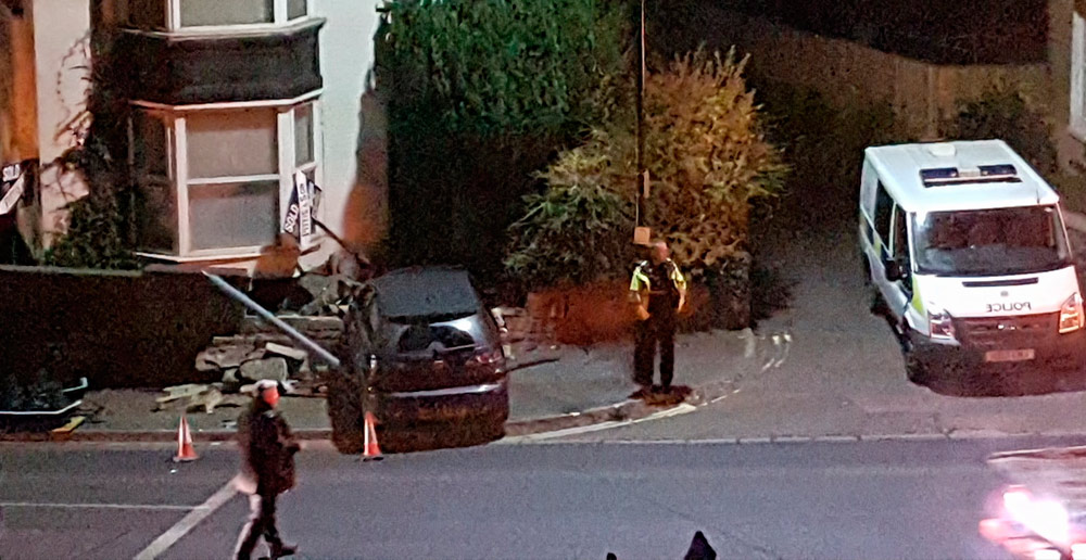 CAR WIPES OUT TRAFFIC LIGHTS BEFORE COLLIDING WITH WALL