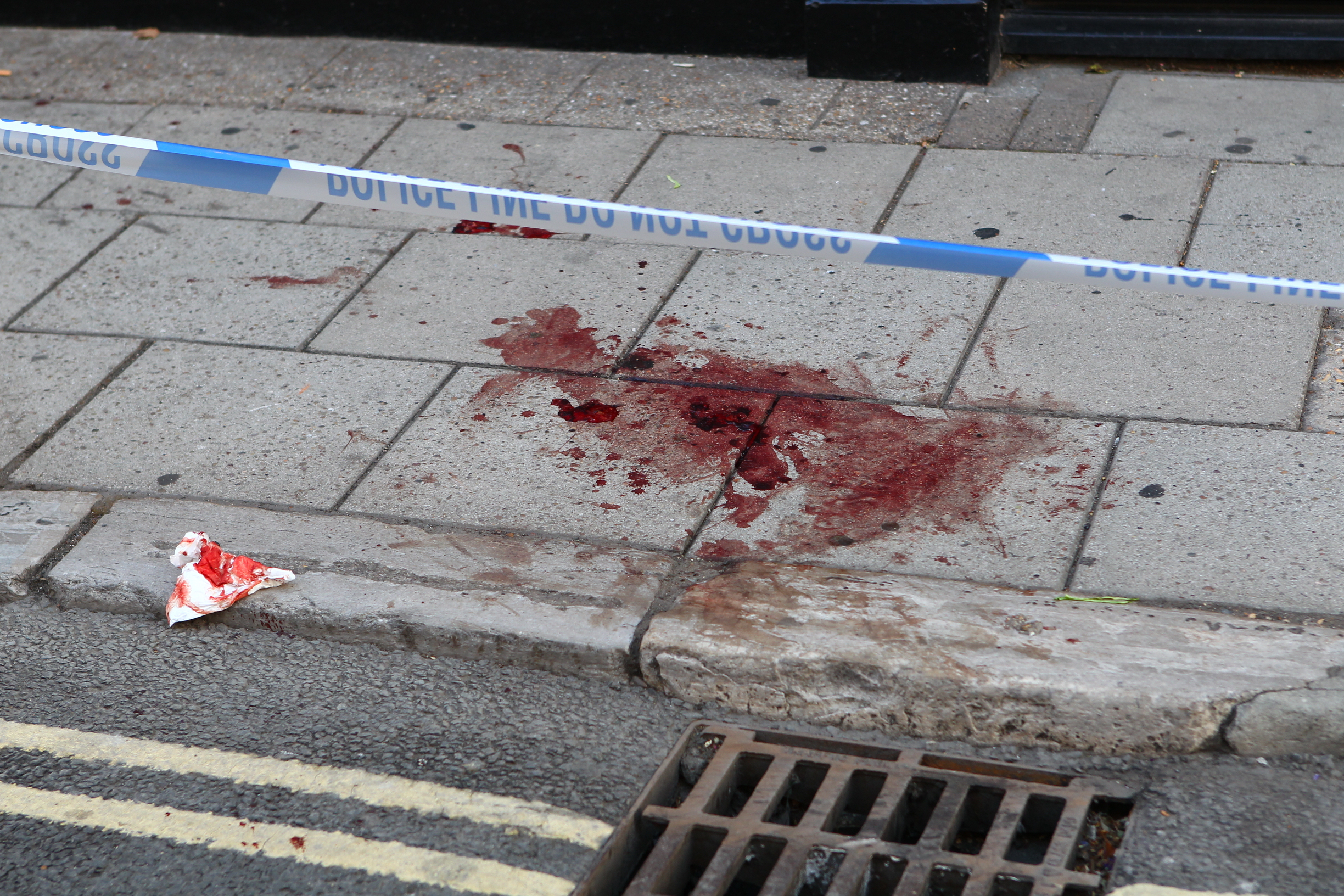POLICE CORDON OFF BLOOD SOAKED PAVEMENT IN RYDE