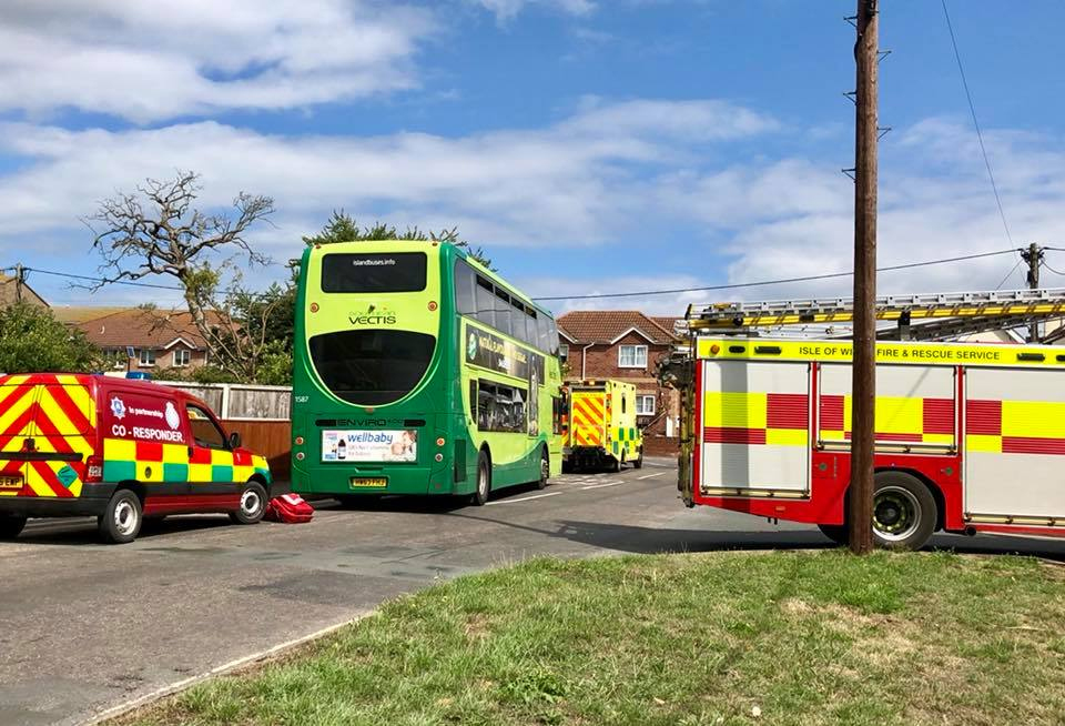 FIREFIGHTERS HELP PARAMEDICS MOVE PATIENT FROM BUS