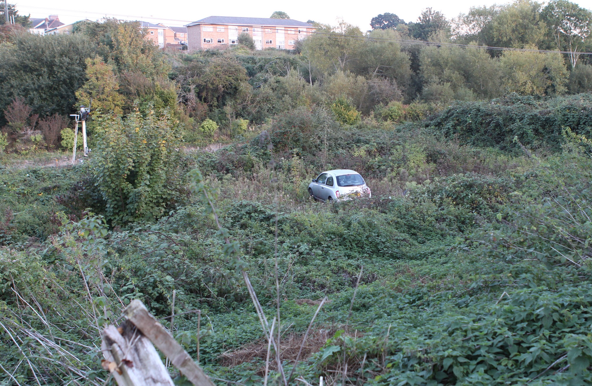 CAR LEAVES ROAD AND TRAVELS DOWN EMBANKMENT NEAR RAILWAY LINE