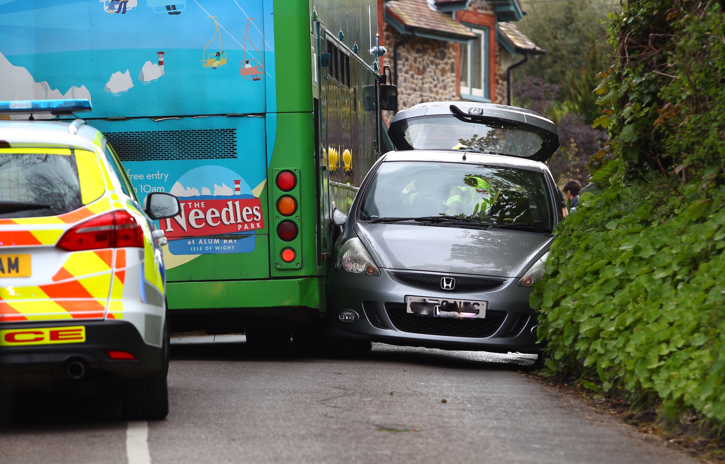 BUS AND CAR BECOME WEDGED IN CRASH NEAR FRESHWATER