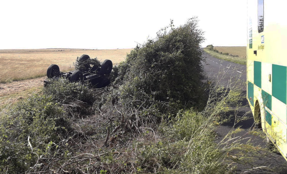 CAR ROLLS INTO FIELD ON MILITARY ROAD