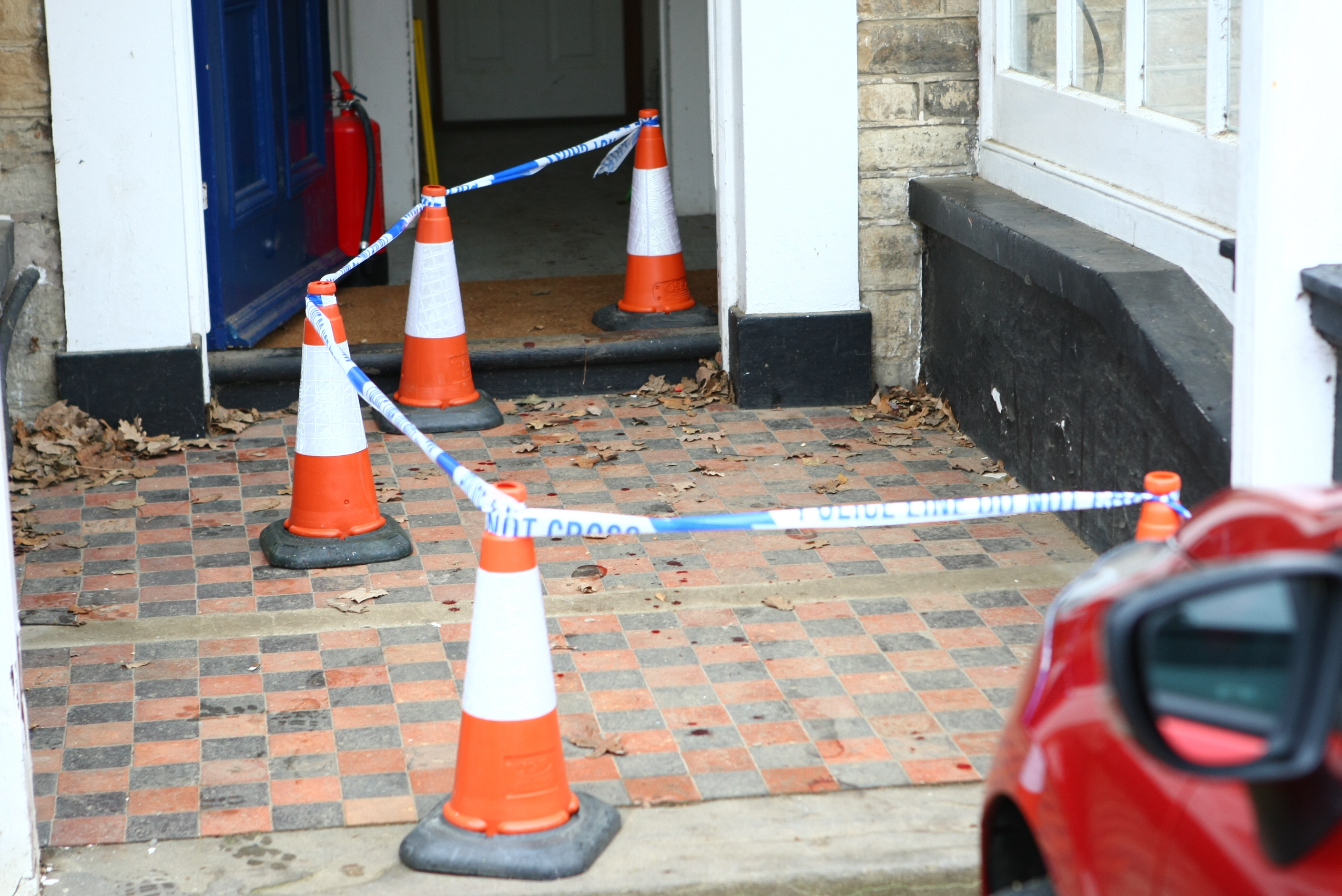 ARMED POLICE IN MANHUNT AS BLOODY CRIME SCENE EXAMINED