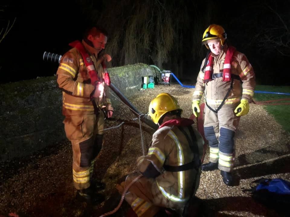 FIREFIGHTERS PUMP FLOOD WATER AWAY FROM PROPERTY IN CALBOURNE