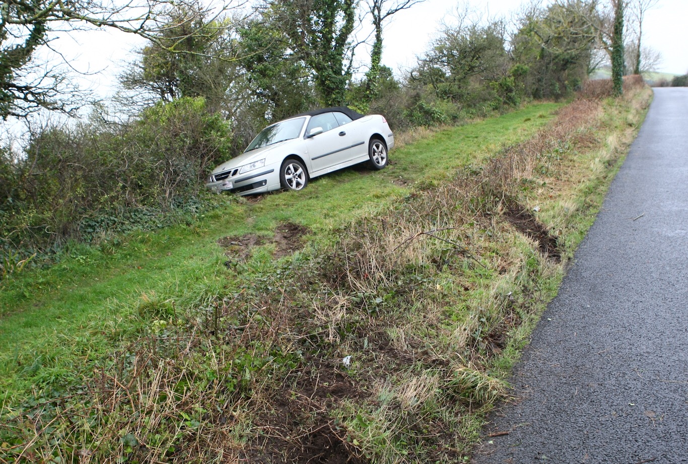 PERSON TRAPPED AS VEHICLE LEAVES THE ROAD NEAR CLIFF EDGE