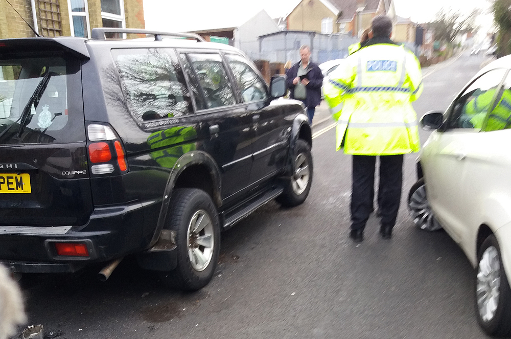 ROAD CLOSED AFTER CAR COLLIDES WITH PARKED VEHICLE