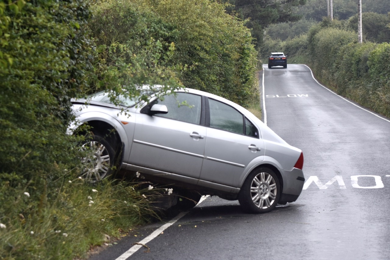 WHITWELL ROAD CLOSED AFTER VEHICLE CRASHES INTO HEDGE