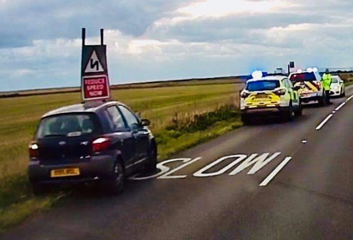 CAR CRASHES INTO ‘REDUCE SPEED’ SIGN ON MILITARY ROAD