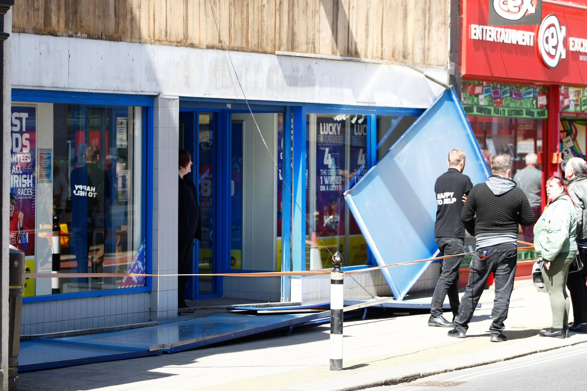 WHAT ARE THE ODDS! BETTING SHOP SIGNAGE FALLS DOWN IN BUSY TOWN CENTRE