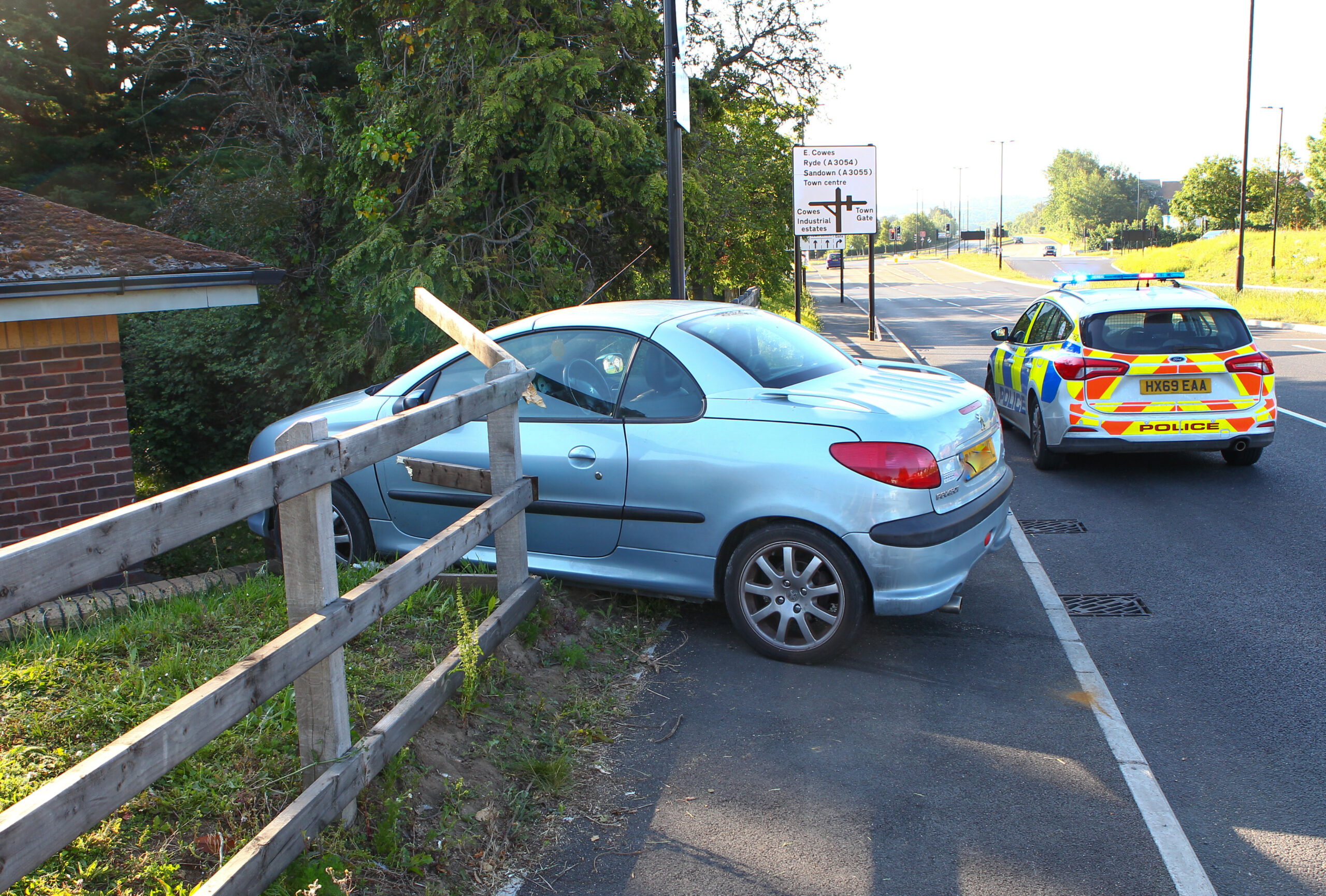 CAR NARROWLY MISSES BUILDING AFTER PLOUGHING THROUGH FENCE