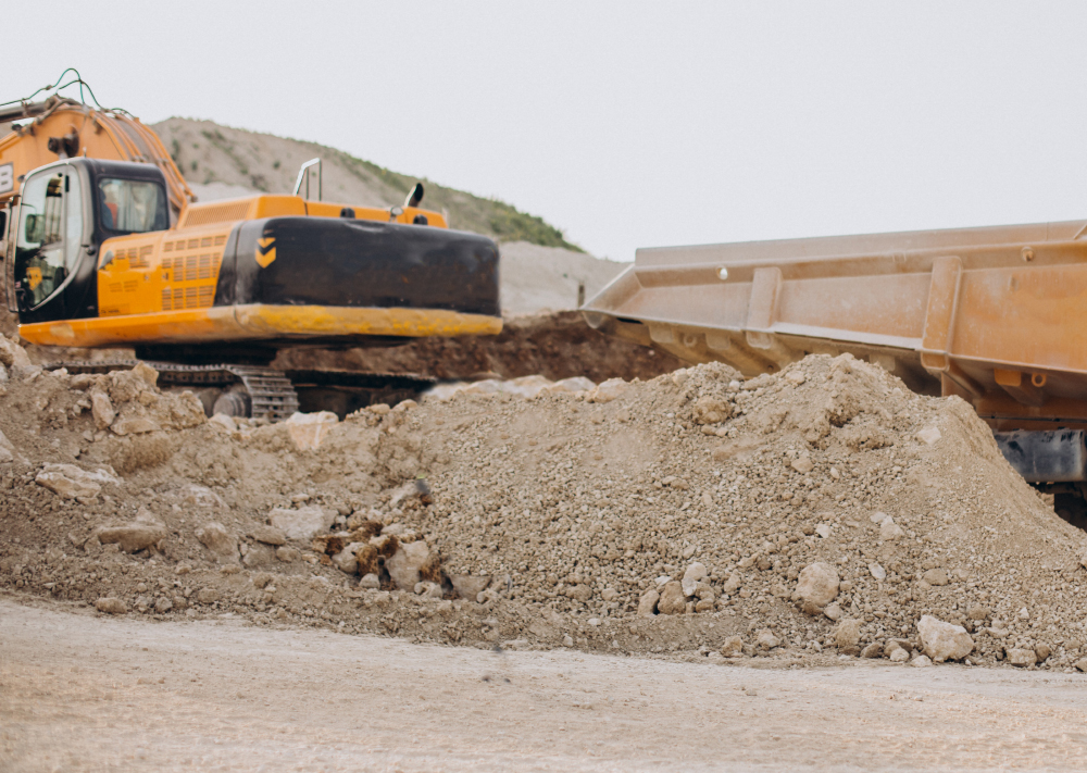 Male Worker With Bulldozer In Sand Quarry