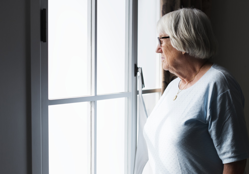 Senior Woman Standing Alone At Home