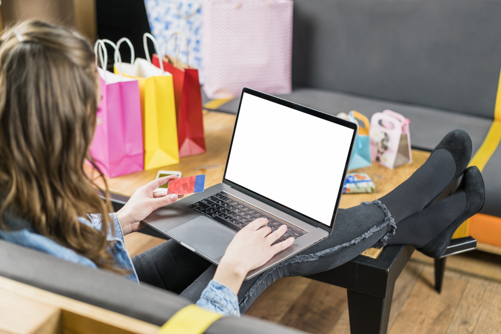 Young-woman-using-credit-card-payment-online-shopping-laptop