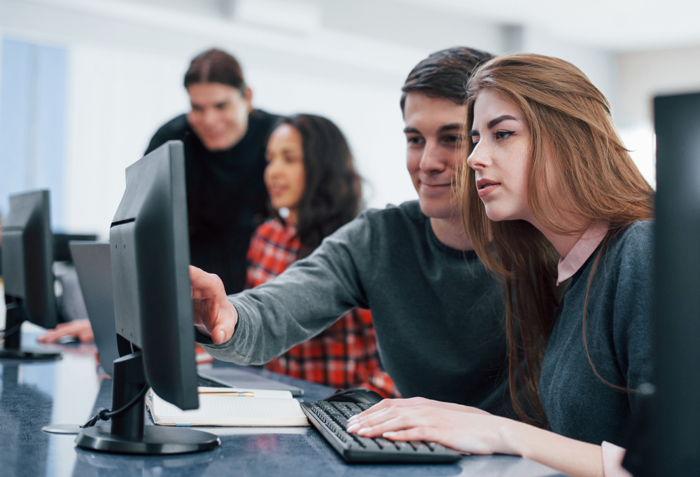 Giving Advice. Group Of Young People In Casual Clothes Working In The Modern Office