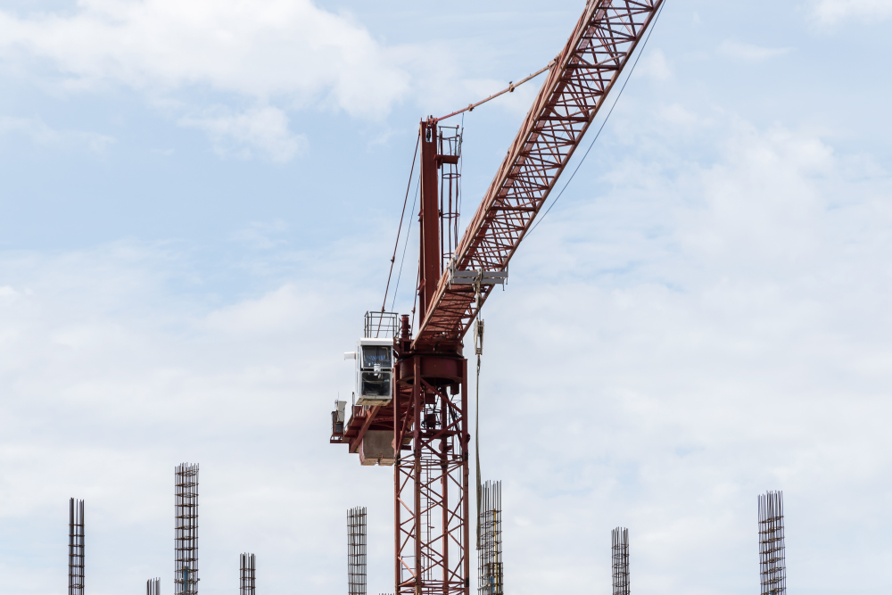 Tower Construction Crane In Building Construction Site With Blue