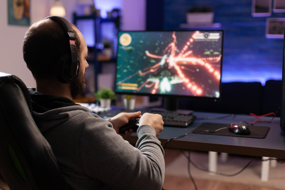 Person Playing Video Games With Controller On Computer
