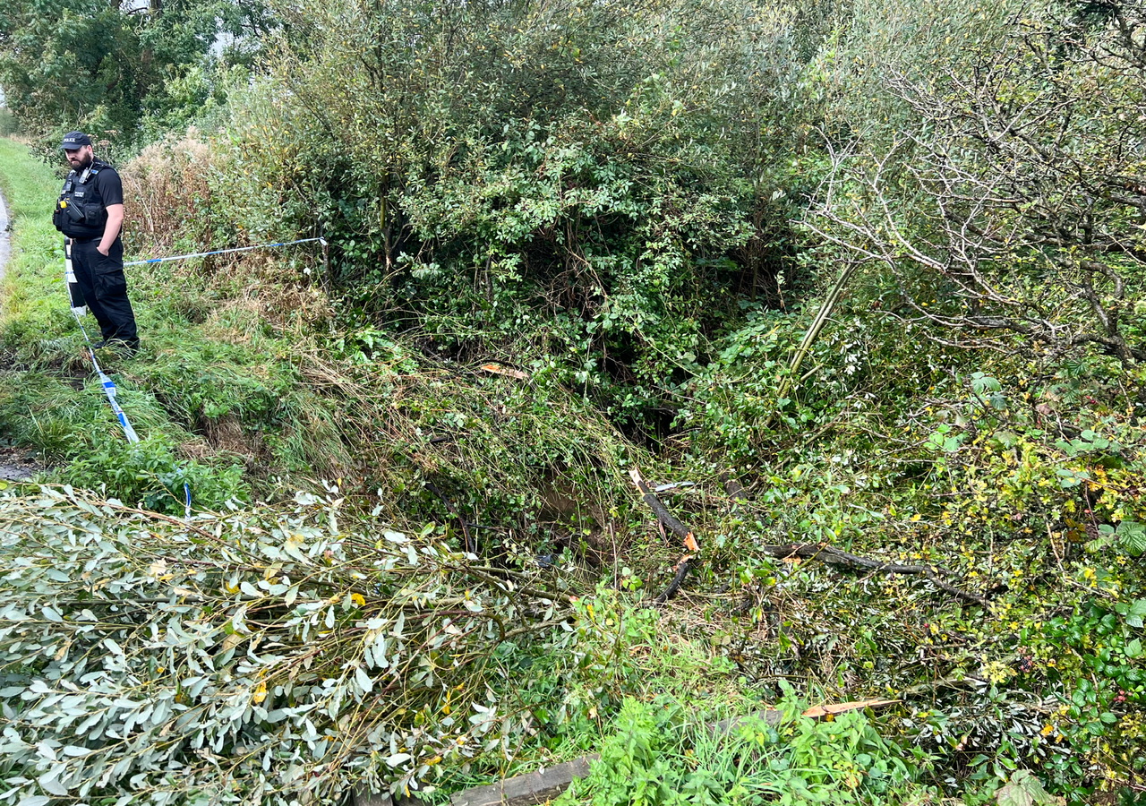 HATCHBACK LANDS UPSIDE DOWN IN STREAM ON MIDDLE ROAD