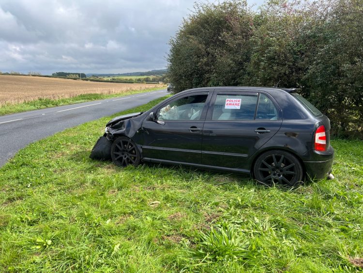 HATCHBACK LANDS UPSIDE DOWN IN STREAM ON MIDDLE ROAD
