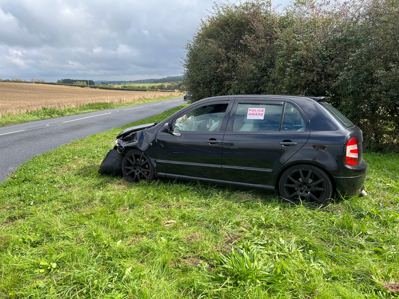 HATCHBACK LANDS UPSIDE DOWN IN STREAM ON MIDDLE ROAD
