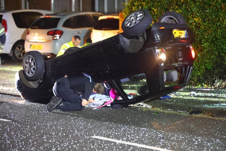 CAR ON ROOF IN LATE NIGHT JUNCTION CRASH – DRIVER FLEES THE SCENE