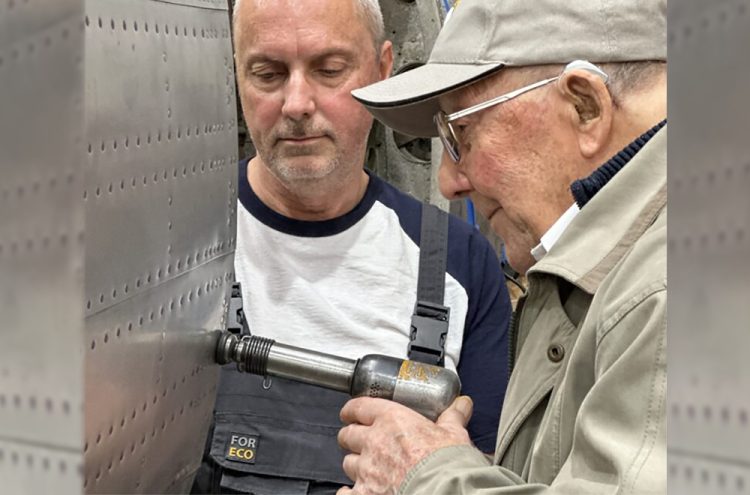 ISLAND CENTENARIAN AND RAF VETERAN PLACES FINAL RIVETS ON HAWKER TYPHOON FUSELAGE