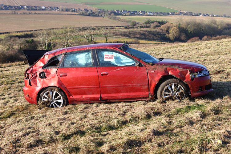 AUDI MANAGE THAT? CAR ROLLS OFF ROAD AND INTO FIELD ON THE DOWNS