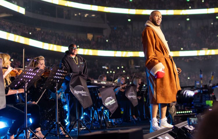 Chris Eubank Jr with Symphonix Orchestra performing behind him at Tottenham Hotspur Stadium before boxing clash with Conor Benn