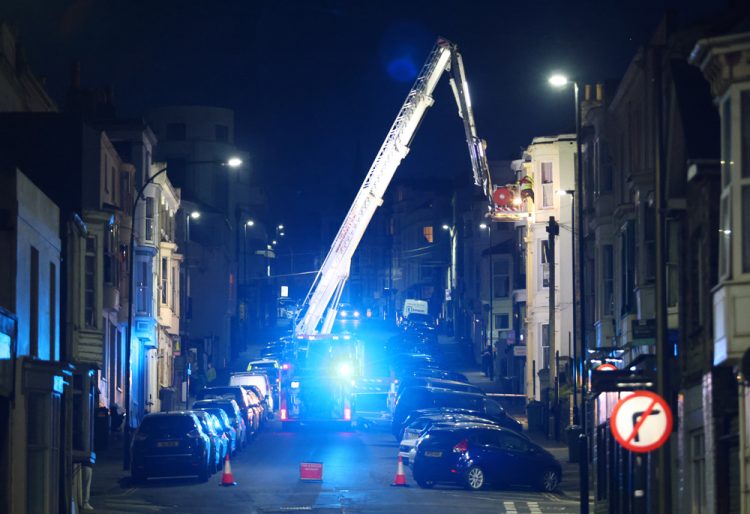 FIREFIGHTERS WORK AT HEIGHT TO REMOVE CASUALTY FROM TOP FLOOR FLAT