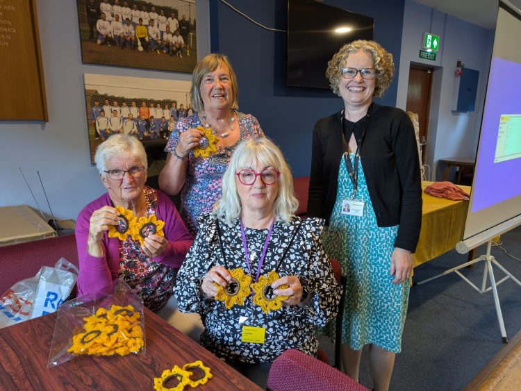 FRESHWATER BAY WI SUPPORTS MOUNTBATTEN WITH HANDMADE SUNFLOWER SCRUNCHIES