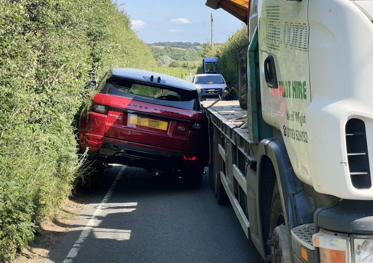 BOOT ESCAPE FOR DRIVER AND PASSENGER AS CAR BECOMES WEDGED WITH LORRY NEAR WHITWELL
