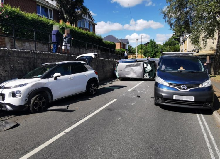 DRIVER FLIPS CAR AFTER SMASHING INTO PARKED VEHICLE ON BUSY NEWPORT ROAD