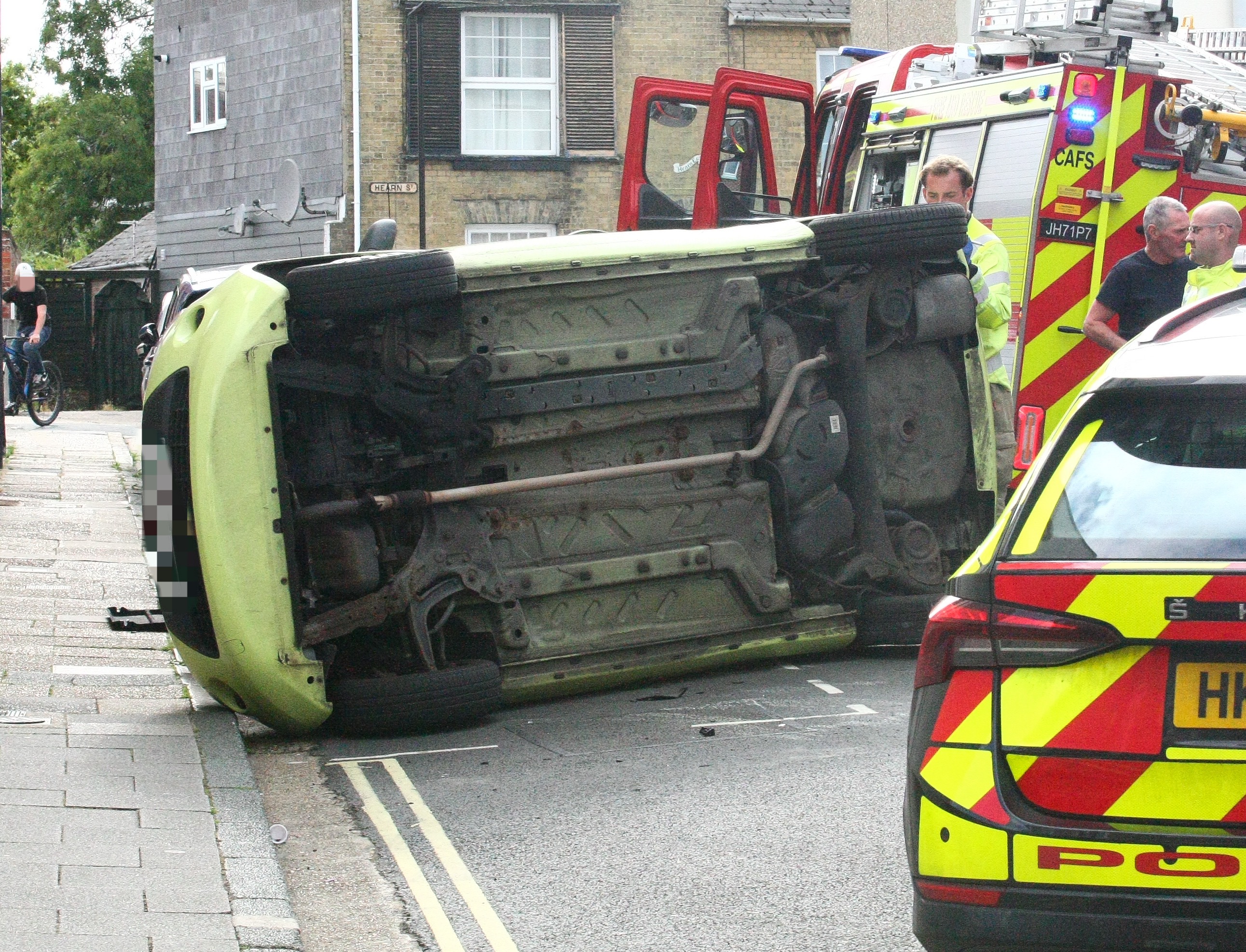 CAR ON ITS SIDE BLOCKS ROAD IN NEWPORT TOWN CENTRE