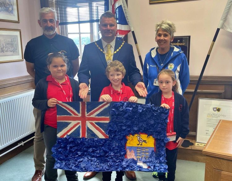 CHAIRMAN WELCOMES OAKFIELD PUPILS AFTER FLAG COMPETITION WIN