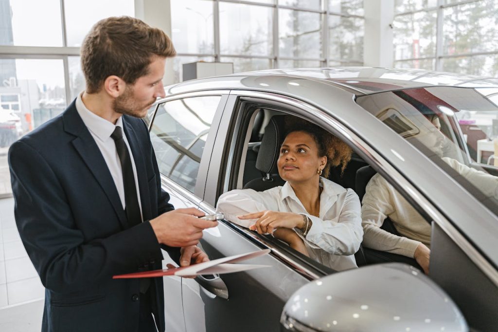 Woman sitting in her new car after verifying the VIN check was okay