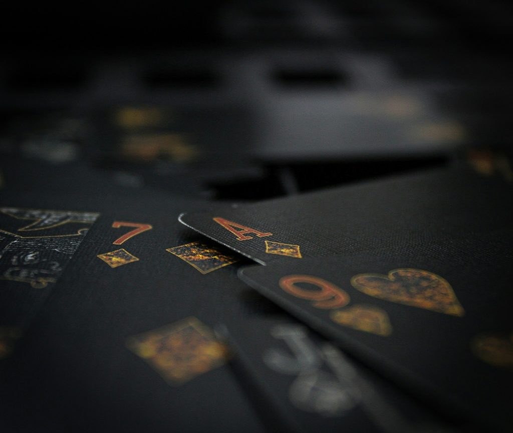 A close up of black playing cards with numbers on them.