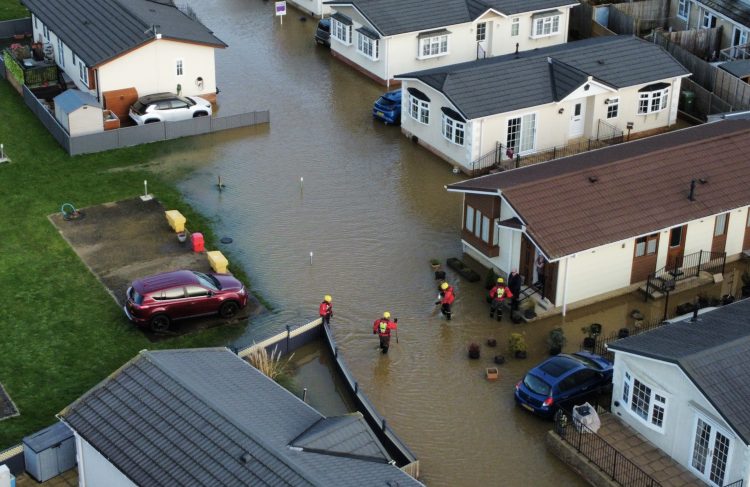 RESIDENTS EVACUATED FROM MOBILE HOME SITE AS FLOOD WATER RISES