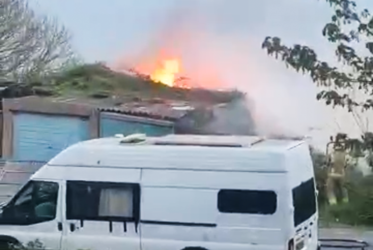 FLAMES THREATEN GARAGES AS FIRE BREAKS OUT ON HILL SIDE IN VENTNOR