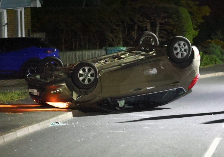 MAN ARRESTED AFTER CAR ENDS UP ON ROOF IN EVENING CRASH IN SANDOWN