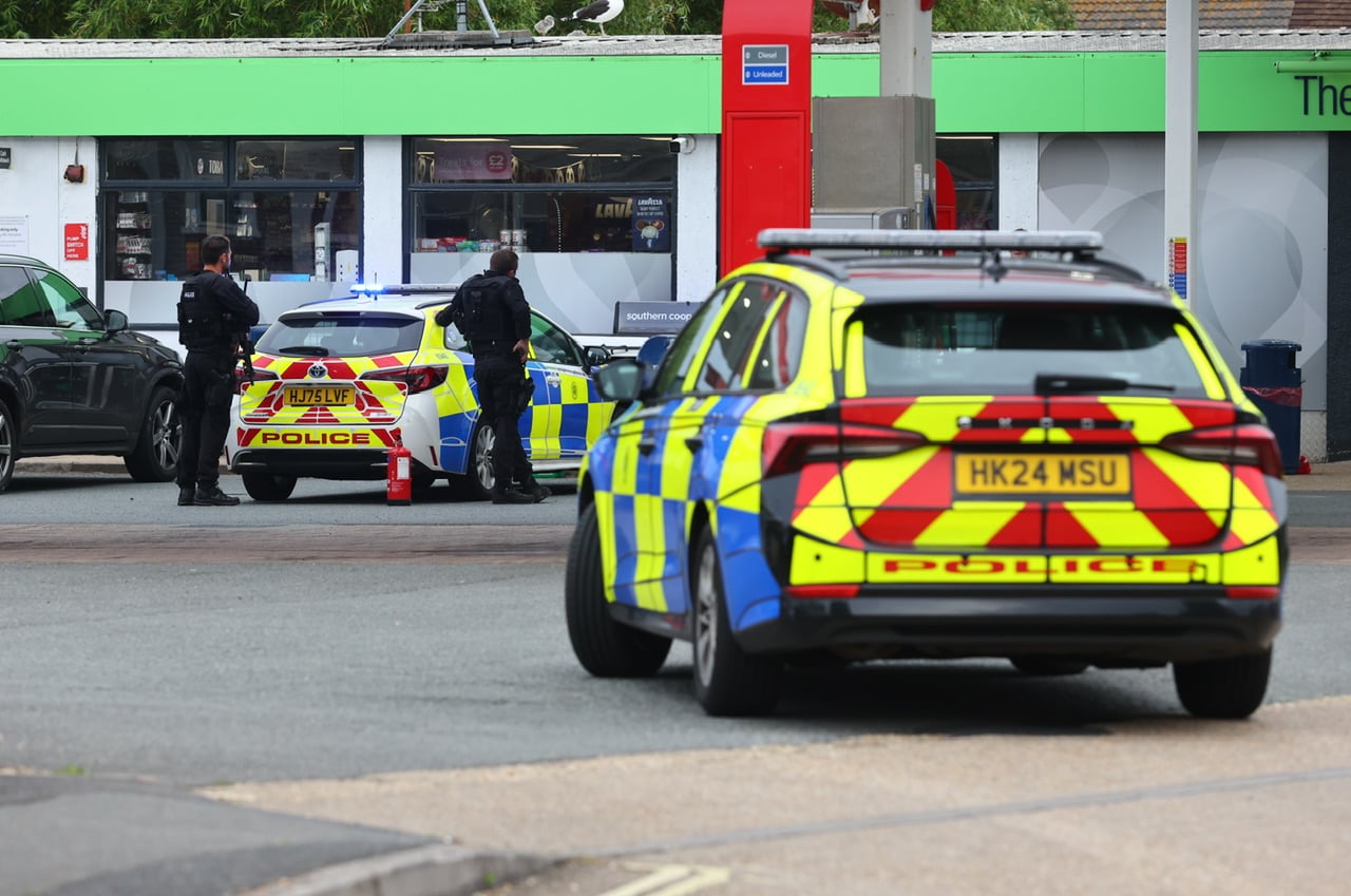 ARMED POLICE NEGOTIATING WITH KNIFEMAN IN PETROL STATION DRAMA