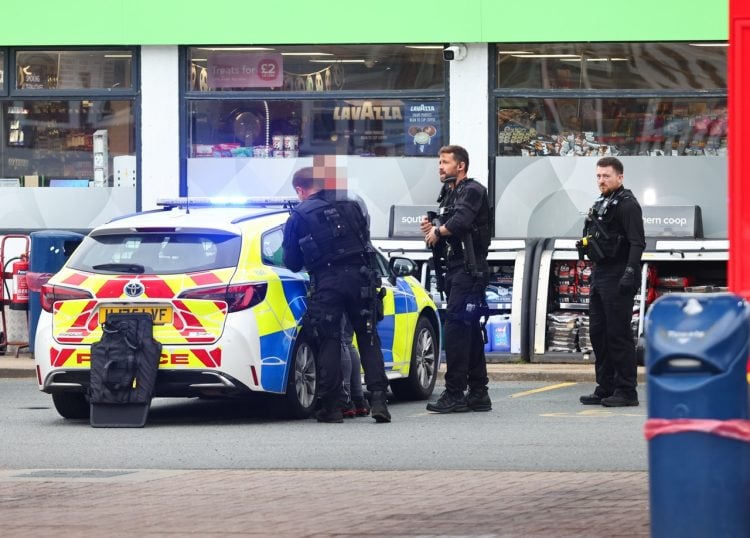POLICE NEGOTIATE WITH ARMED MAN IN PETROL STATION STANDOFF