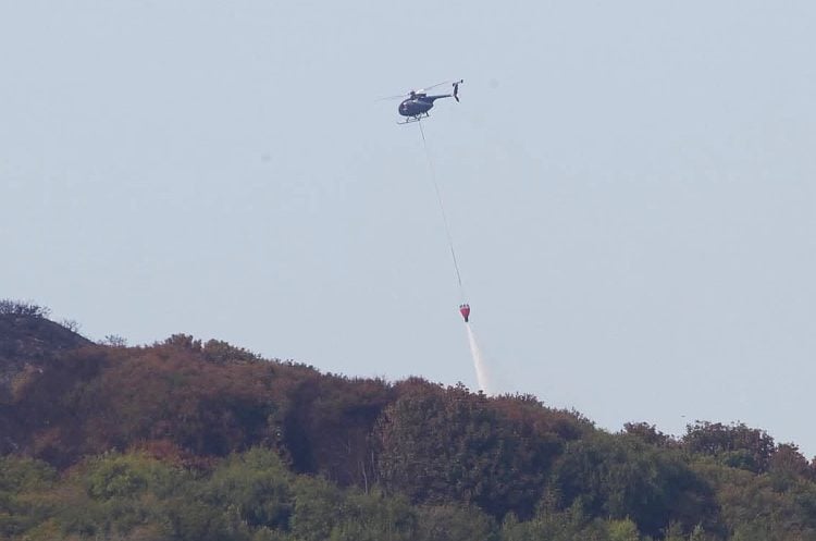 HELICOPTER DRAFTED IN TO DOUSE HEADON WARREN WILDFIRE WITH SEAWATER