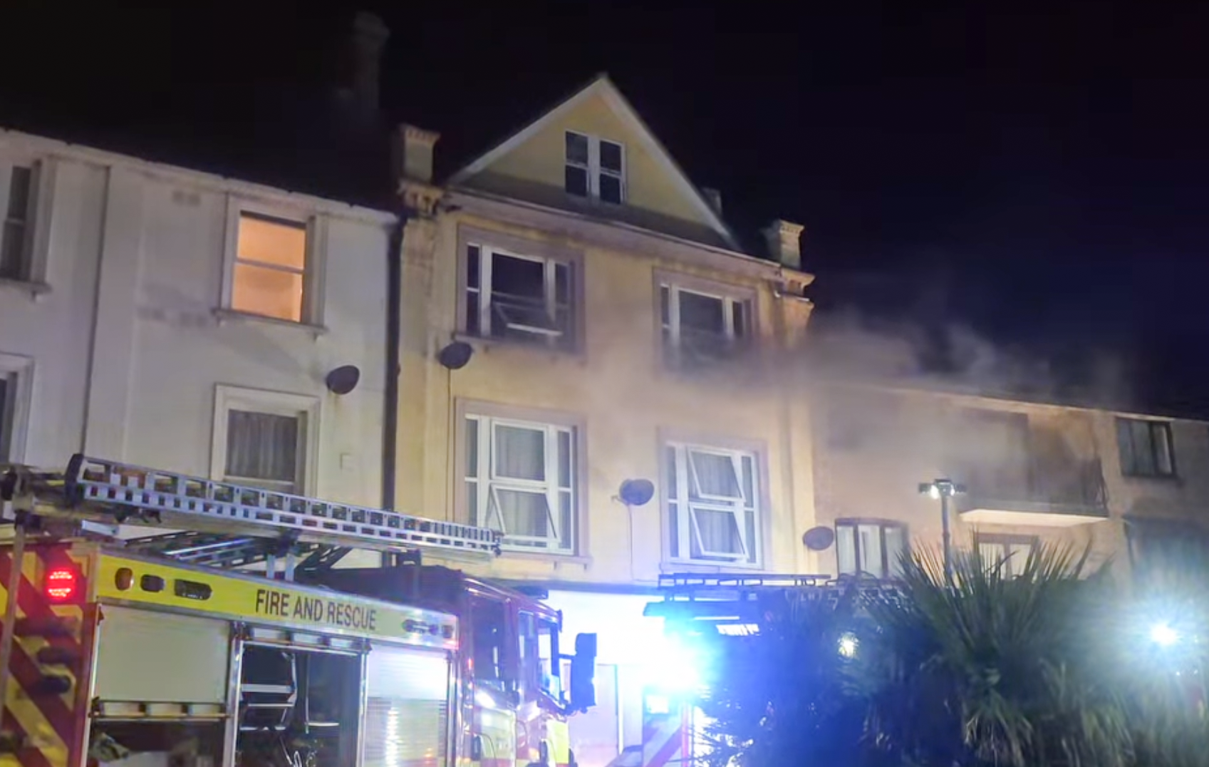 BLACK SMOKE ISSUES FROM WINDOWS IN LATE NIGHT SANDOWN FLAT FIRE